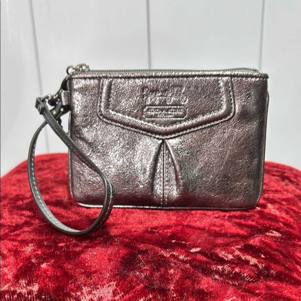 Coach silver metallic leather wristlet with silver tag and strap